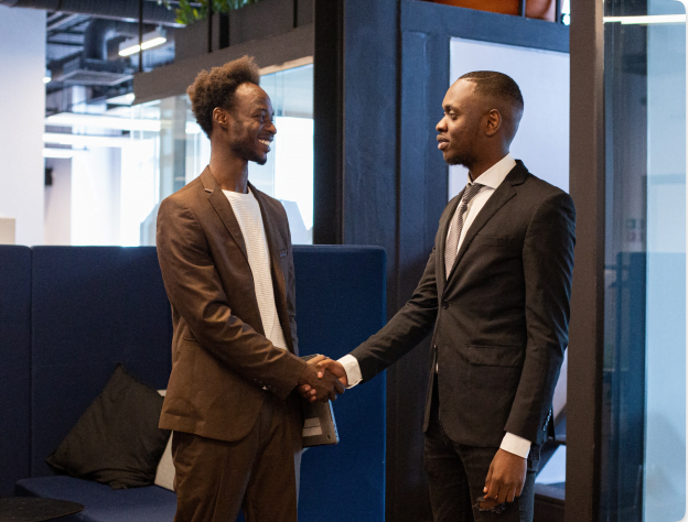 two_young_seniour_accountants_shaking_hands